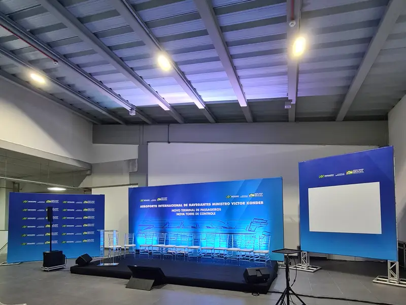 Palco de evento com backdrops e painel lateral